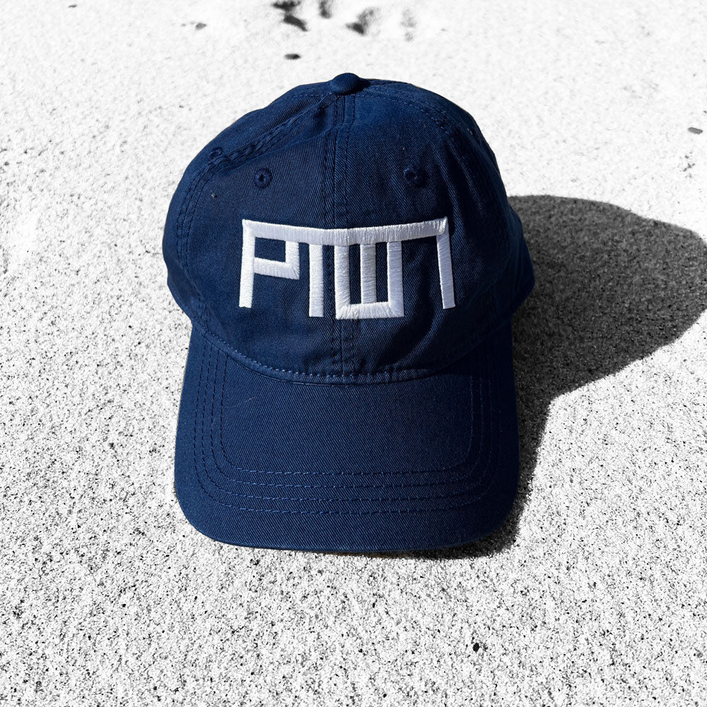 Navy blue cap with white PTOWN logo on a textured surface