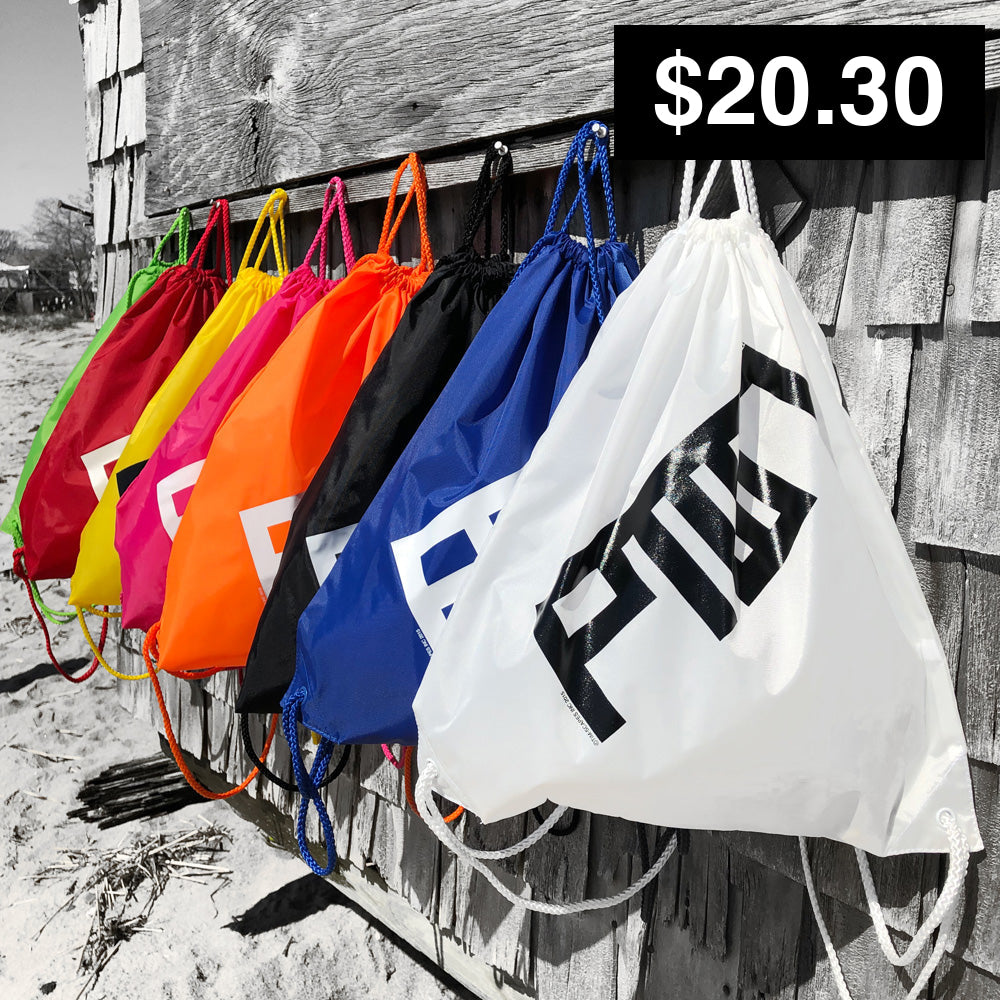 A collection of colorful cinch sacks with drawstrings, hanging on a wooden fence. They come in various colors including pink, yellow, orange, blue, and white, with PTOWN logo printed on the front in black.