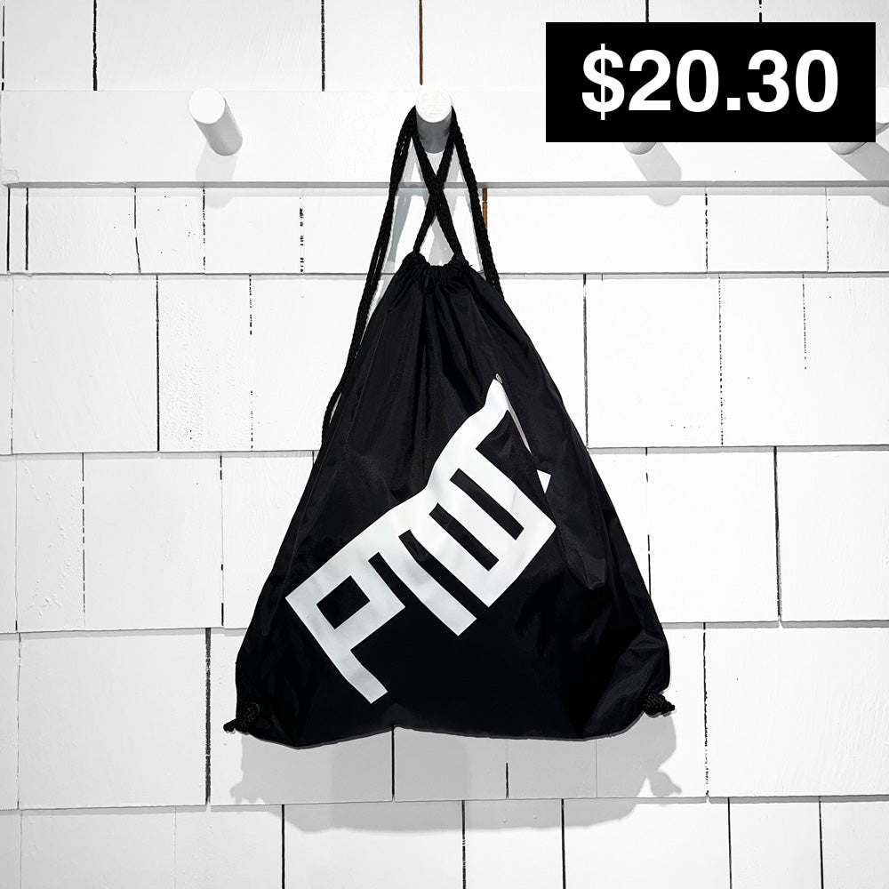 A collection of colorful cinch sacks with drawstrings, hanging on a wooden fence. They come in various colors including pink, yellow, orange, blue, and white, with PTOWN logo printed on the front in black.